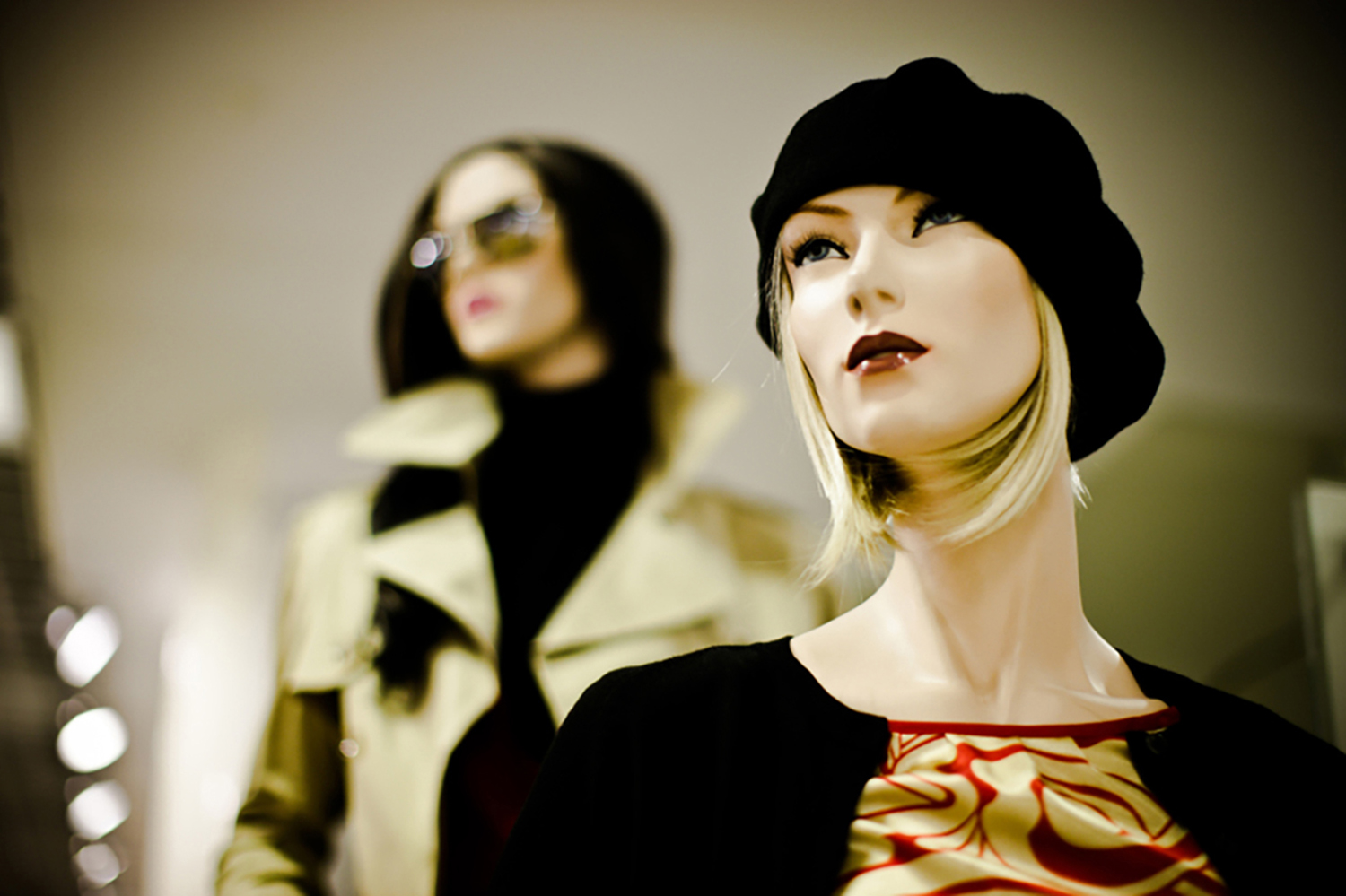 Gros plan sur une vitrine. Deux mannequins féminins sont en vitrine  protégées par un film de sécurité incolore.